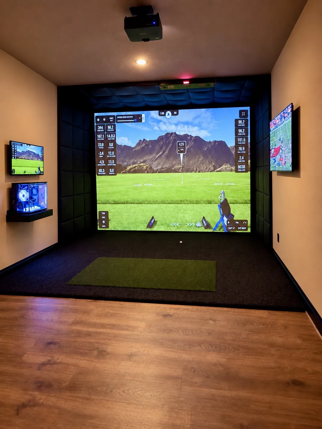 Finished SIMHAUS golf simulator with large impact screen, padded enclosure and hitting mat