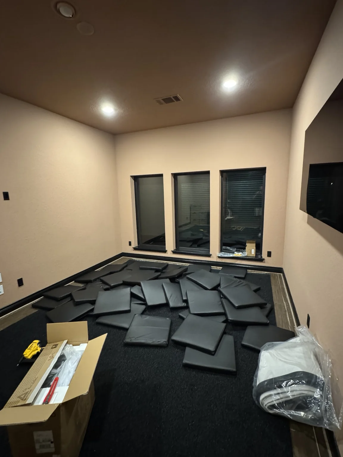 Indoor simulator room during installation with floor padding being laid out